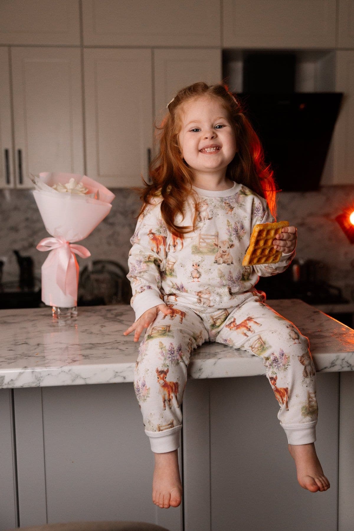Child in night wear holding a gift